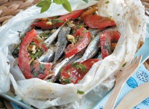 Parchment baked fresh anchovies with tomato and herbs