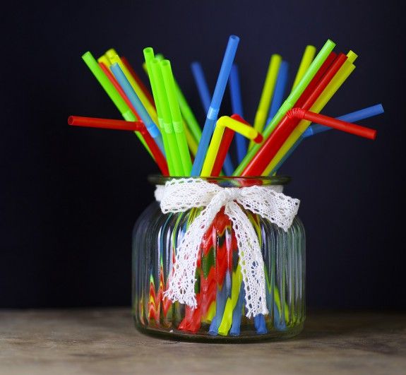 colored plastic cocktail tubes standing in a glass