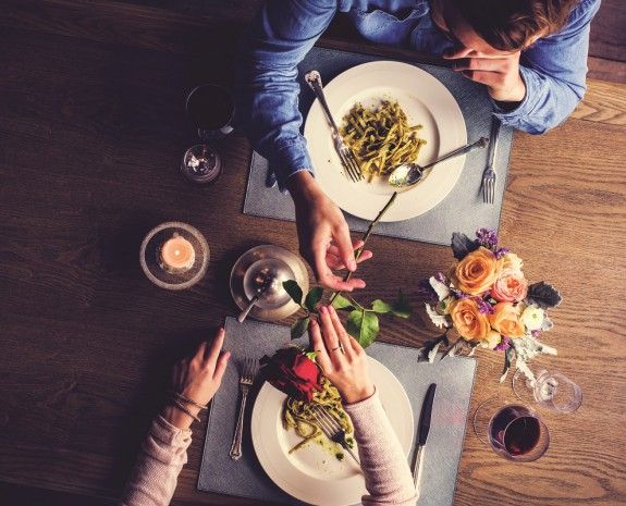 Romantic Man Giving a Rose to Woman on a Date