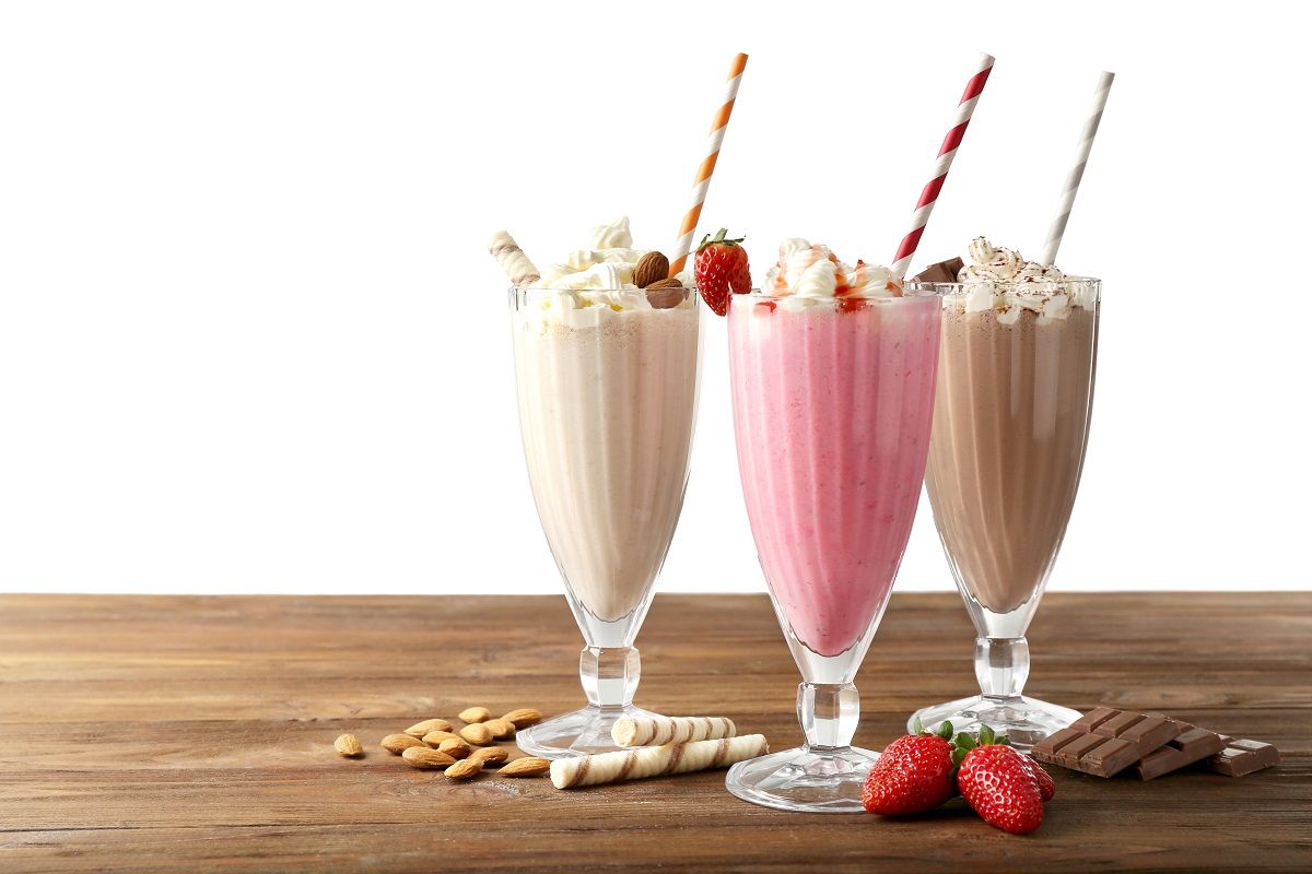 Delicious milkshakes on white background