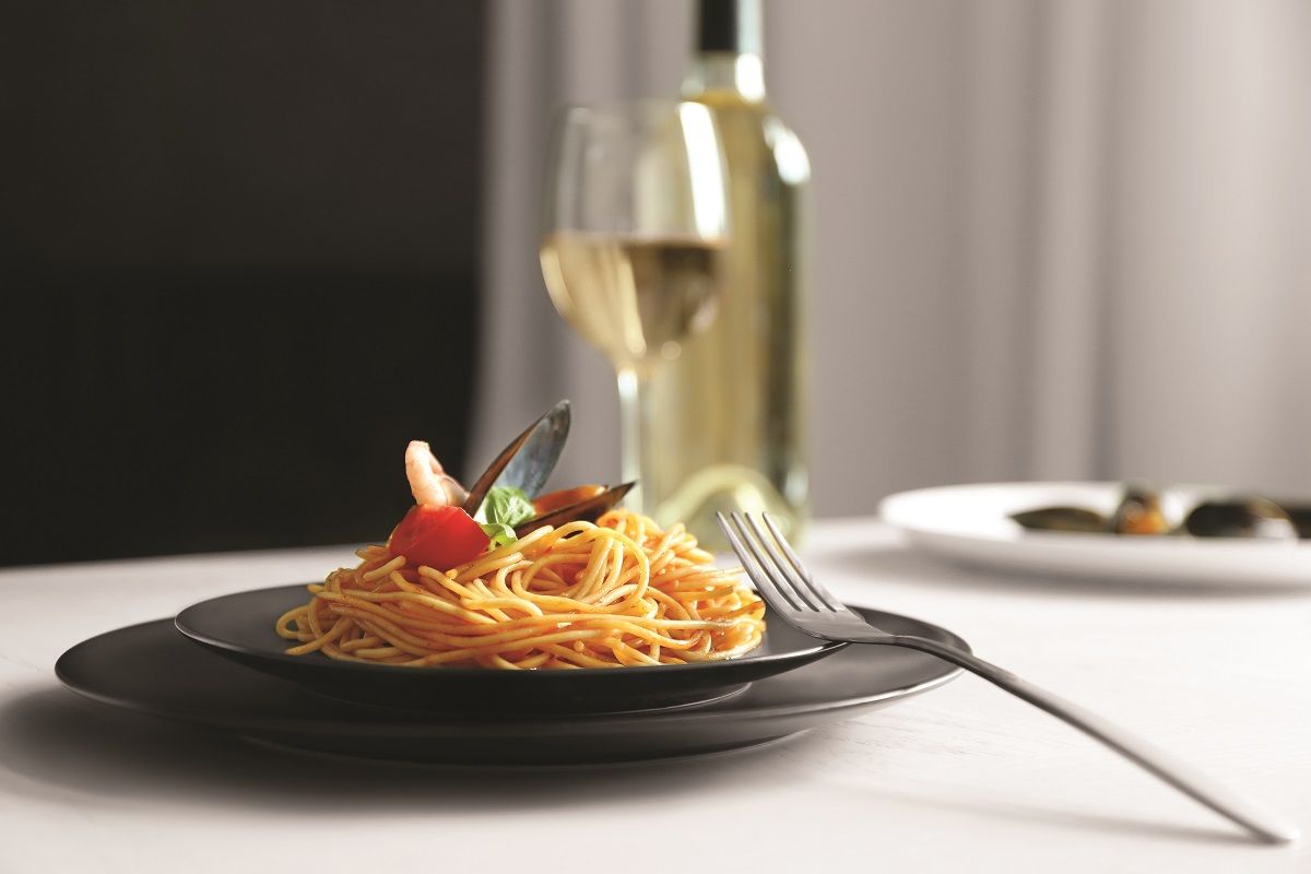 Portion of tasty pasta on served table