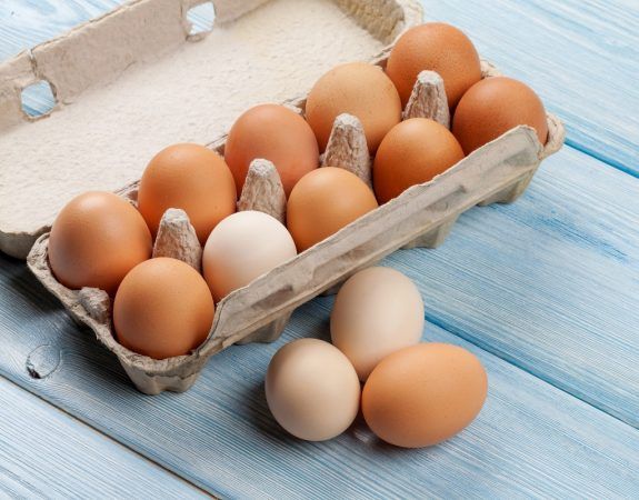 Cardboard egg box on wooden table