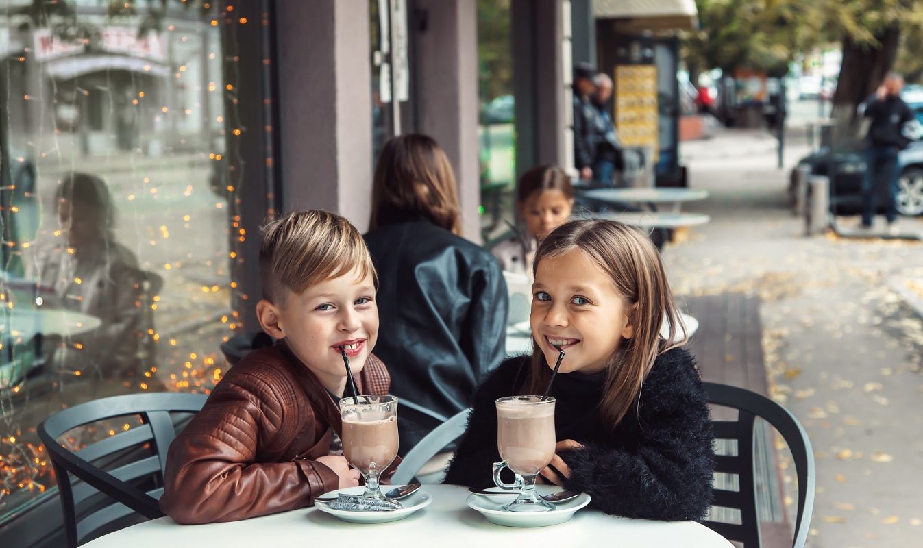 Children having fun in outdoor cafe