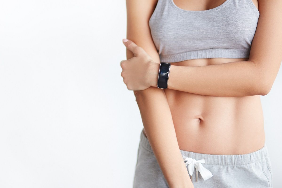 Young woman athlete wearing heart rate monitor.