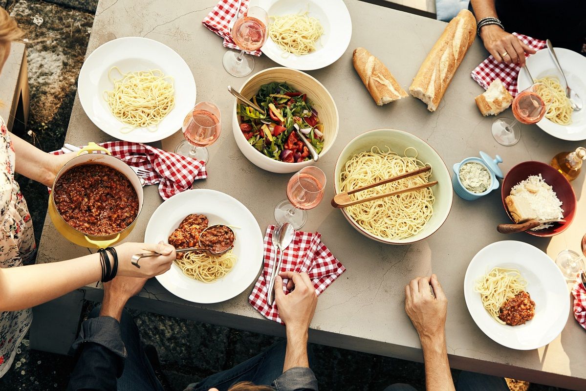 Friends enjoying a meal of spaghetti Bolognaise