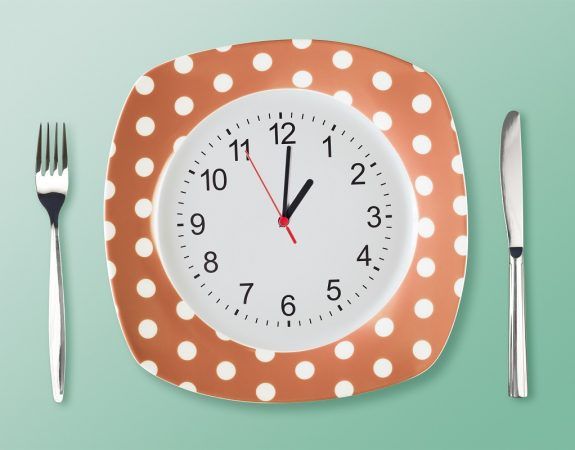 Dinner plate retro style with clock face fork an tableknife