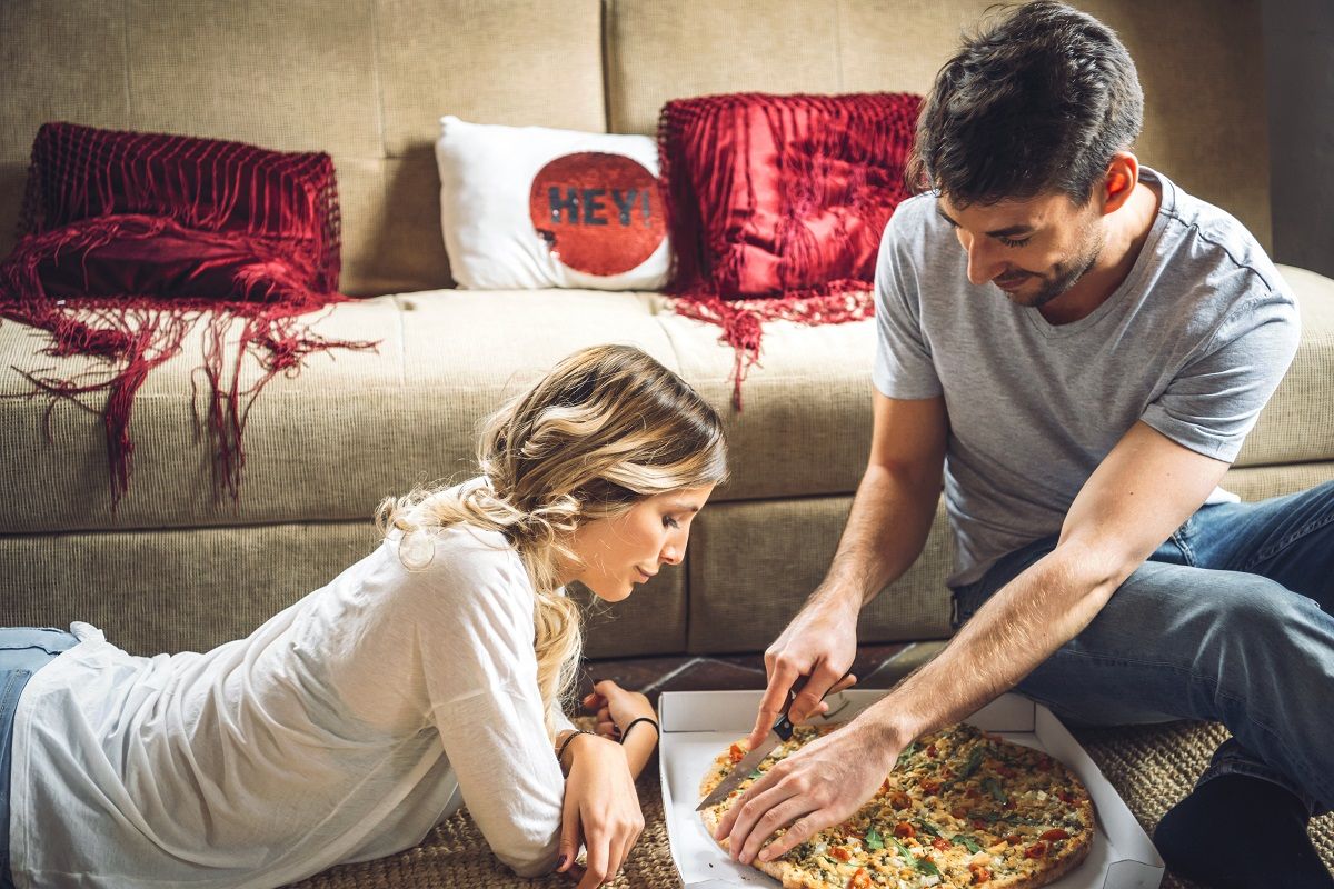 Couple enjoying ordered pizza