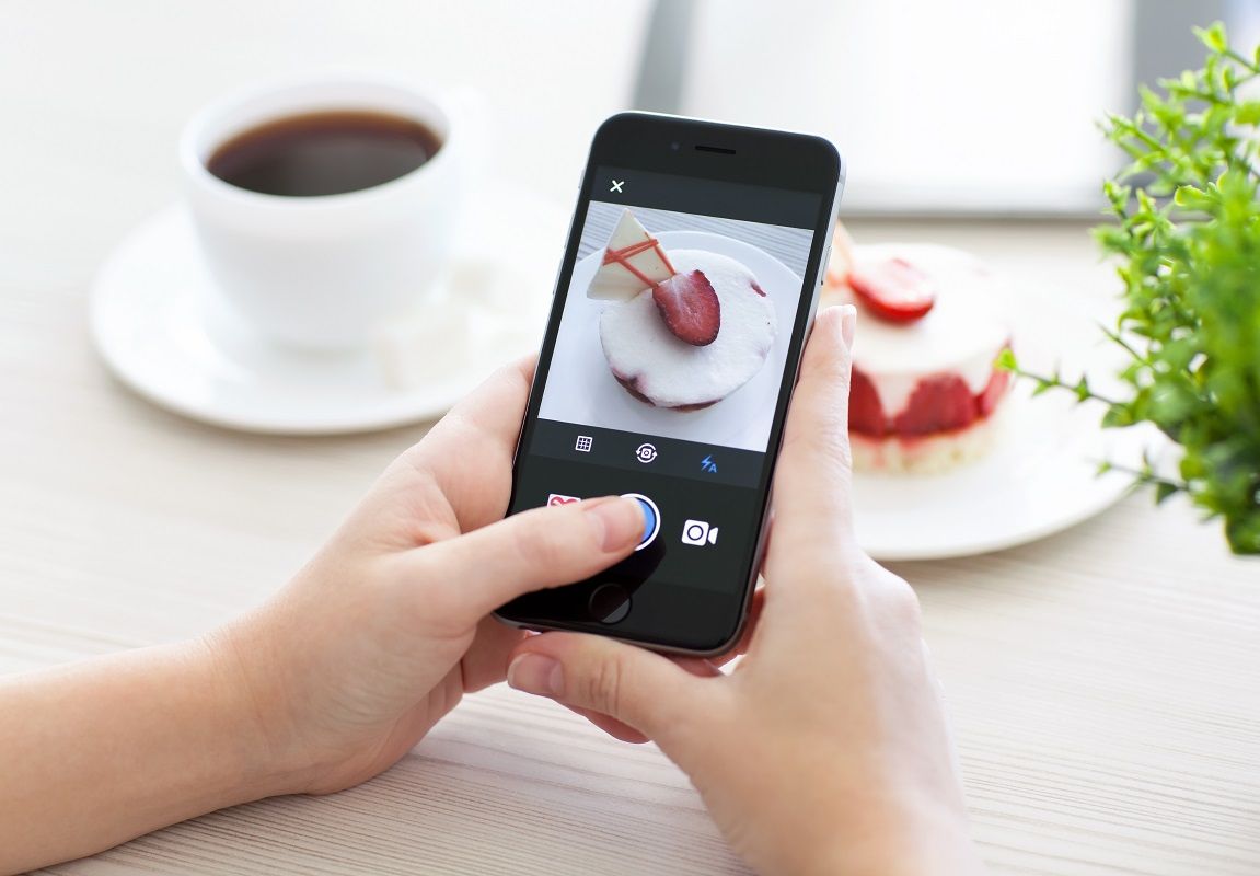 Woman holding iPhone 6 Space Gray with service Instagram