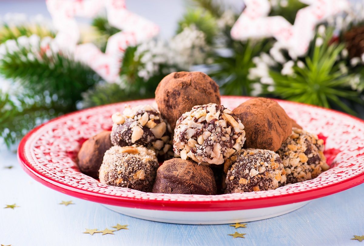 Assorted dark chocolate truffles on red plate
