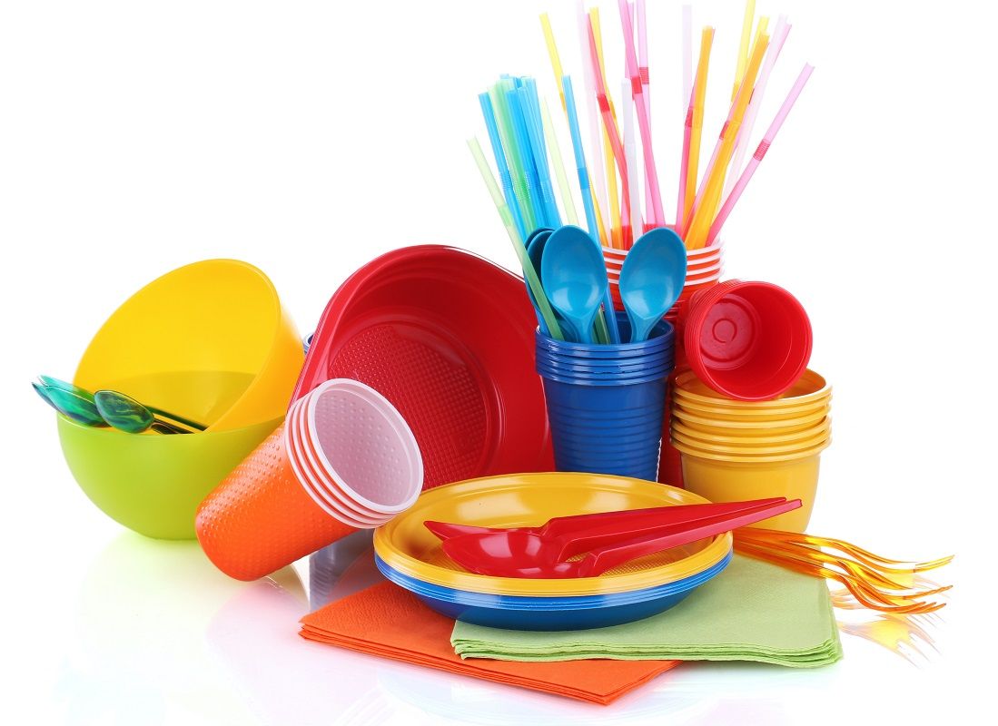 17362493 – bright plastic tableware and napkins isolated on white