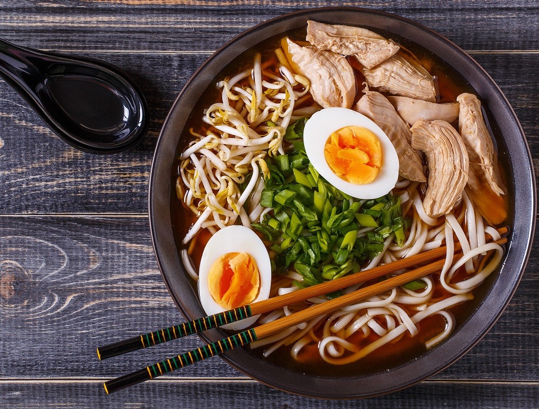 Japanese ramen soup with chicken, egg, chives and sprout.