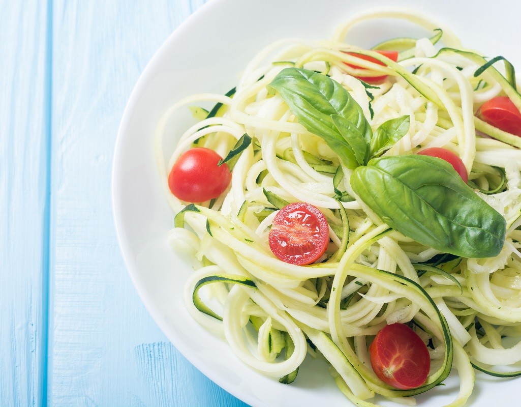 Zucchini pasta noodles with tomatoes . Healthy vegetarian food
