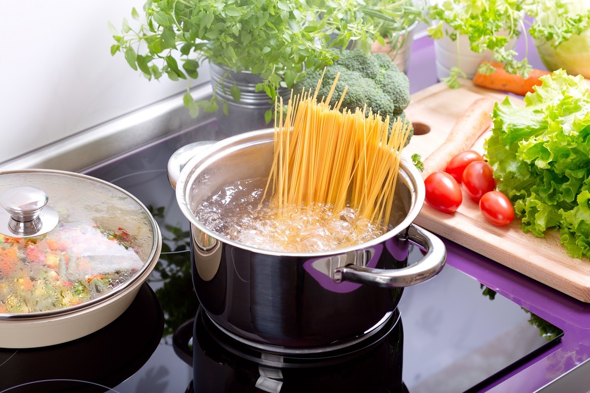 pan of boiling water with spaghetti on the cooker