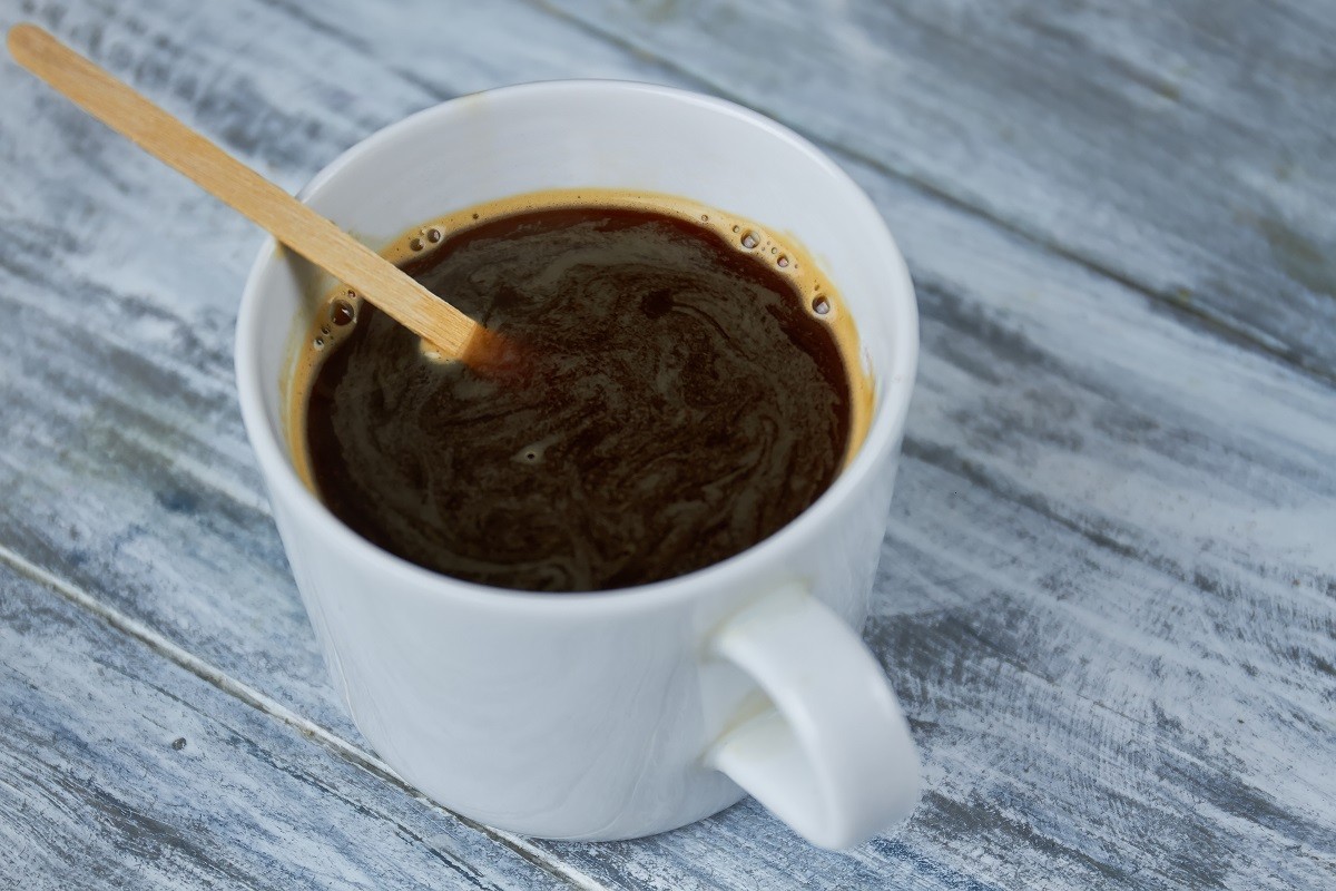 Dark coffee and stir stick.