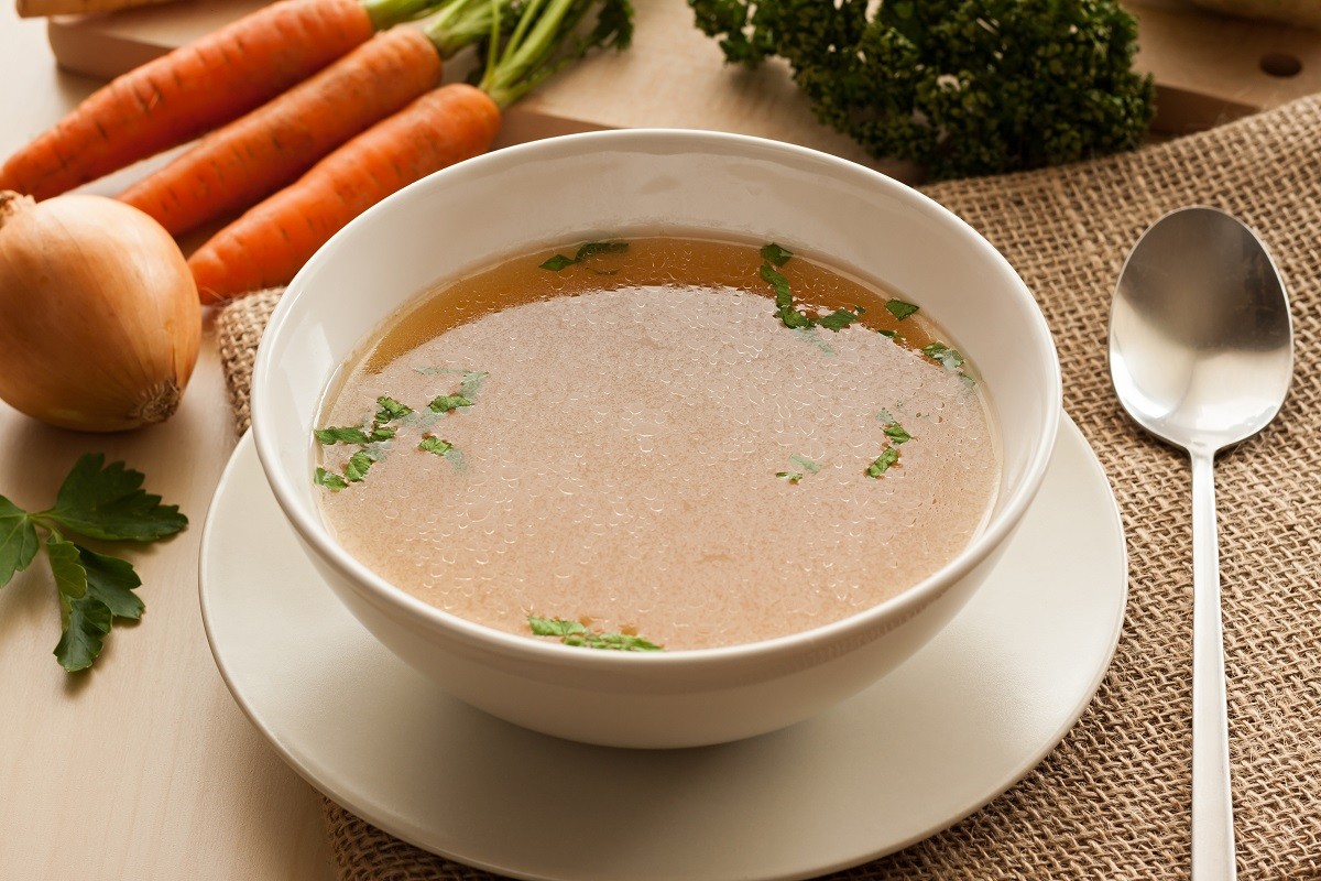 Bone broth made from chicken served in a soup bowl