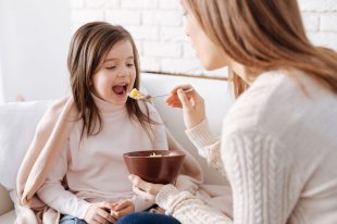 72778409 – positive little girl having breakfast