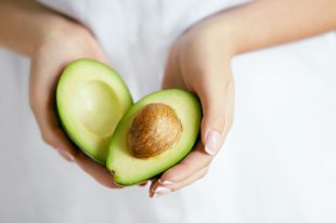 Healthy Food. Avocado In Woman Hands