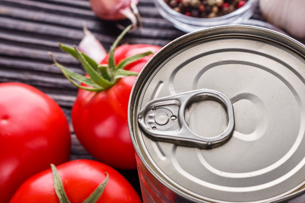 juicy canned tomatoes on wooden rustic background