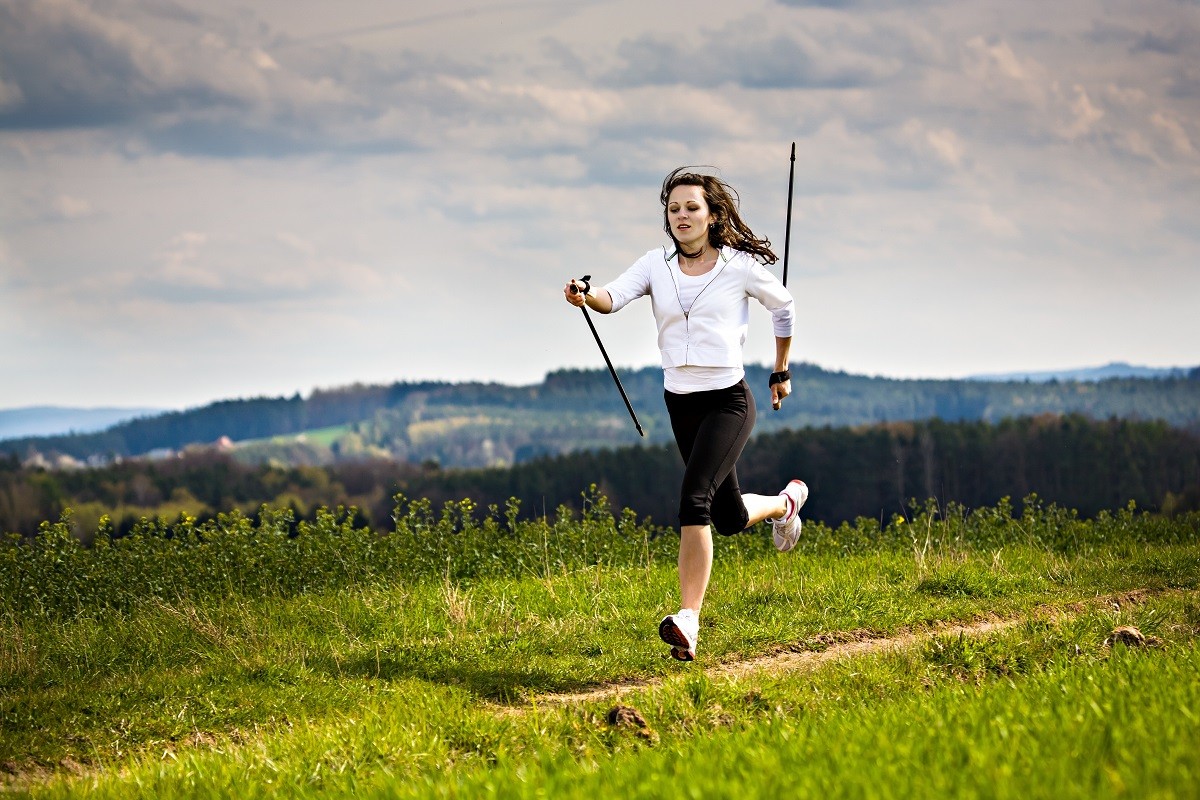 13548636 – a young woman making nordic walking. outdoor shoot.