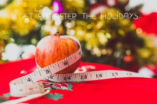 apple with measuring tape and Christmas tree in the background