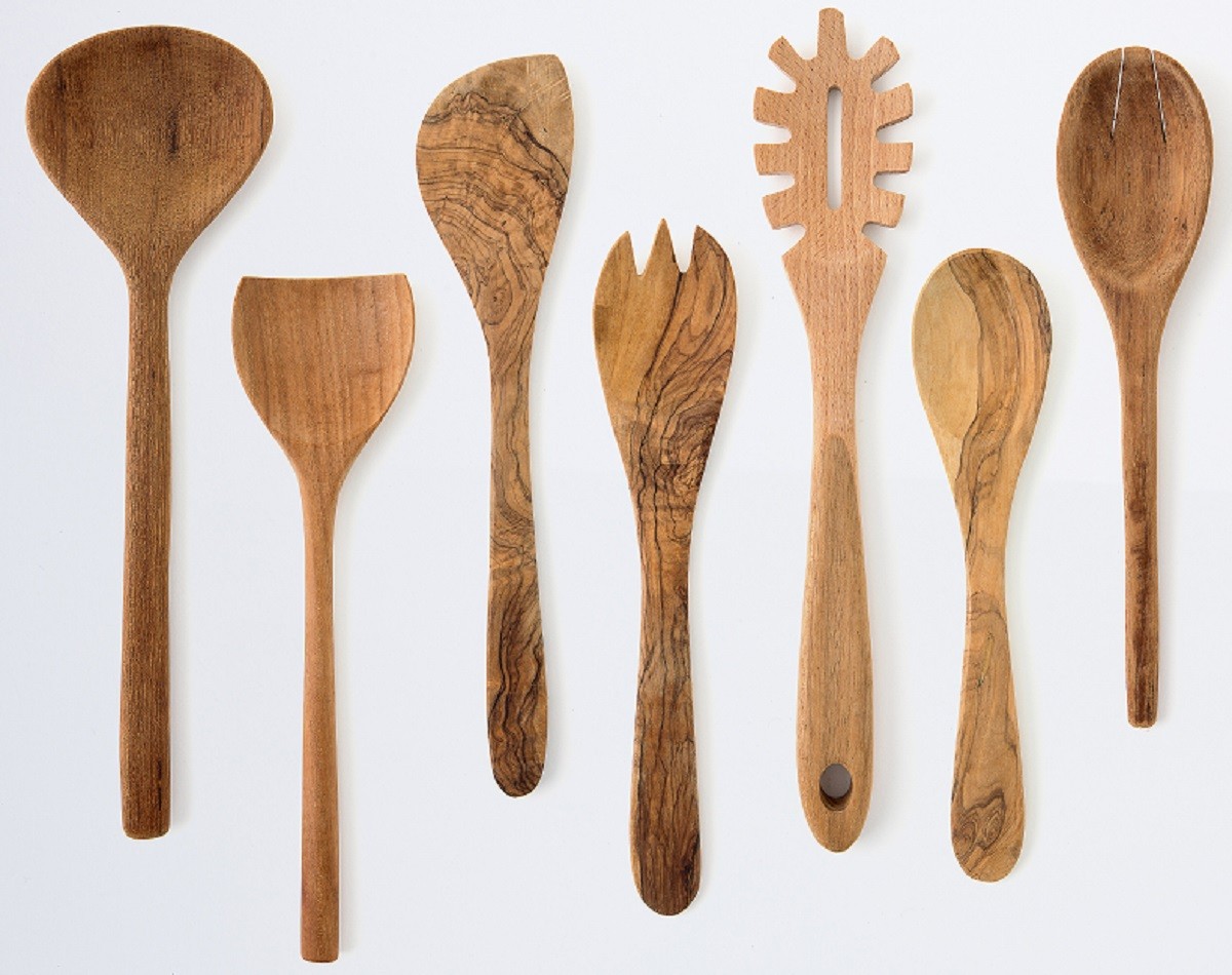 Kitchenware set of wooden fork, spoon and utensils on white back