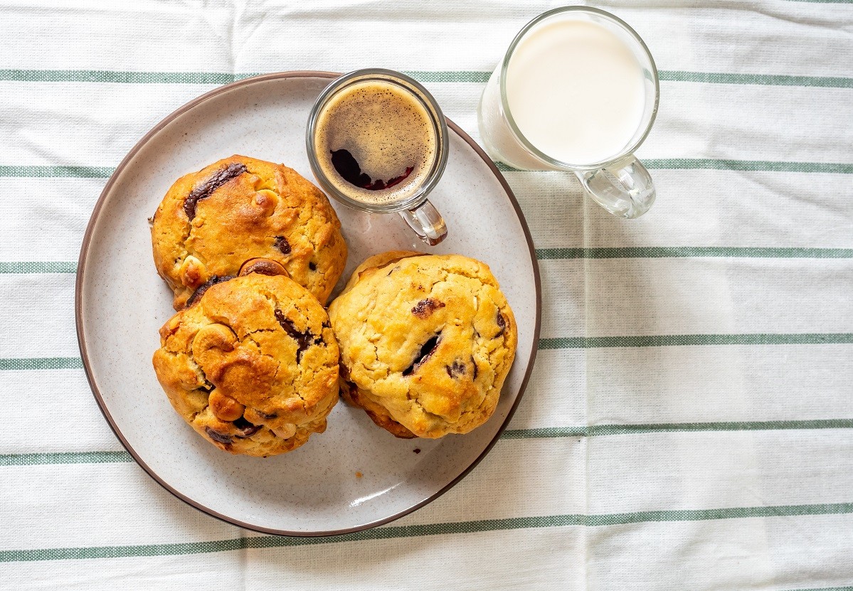 Chewy chocolate chip soft cookies with cup of coffee and milk