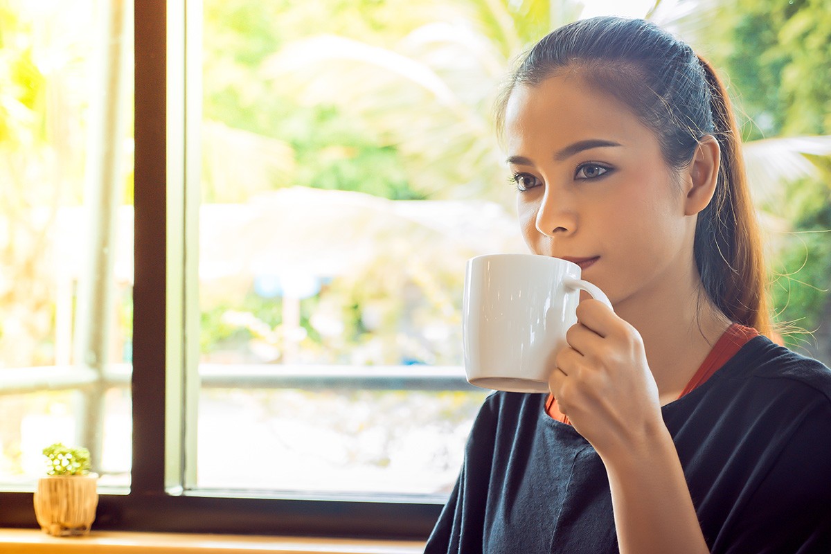 Woman drinking coffee at coffee cafe