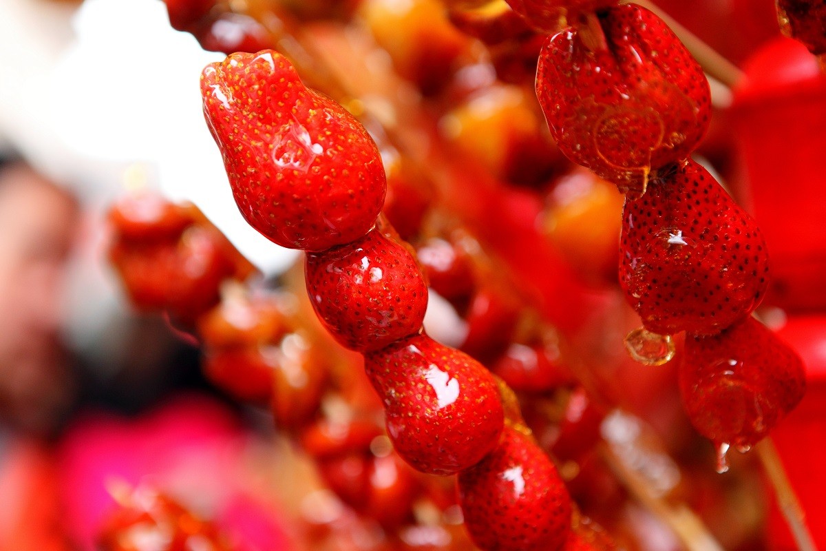 108316448 – close-up of skewered strawberries