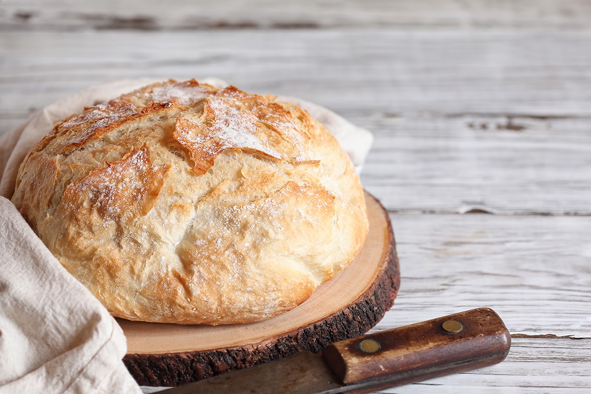 Fresh Artisan Bread on a Cutting Board with Knife