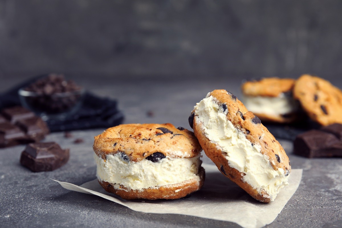 Sweet delicious ice cream cookie sandwiches on table