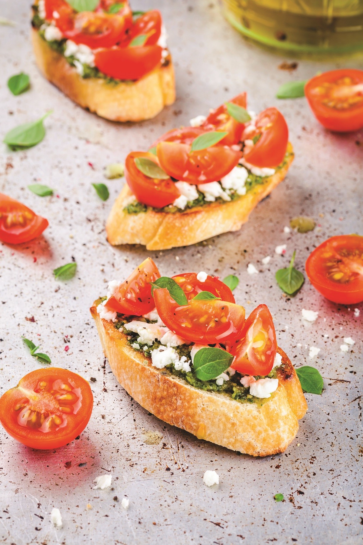bruschetta with pesto  sauce, feta cheese, tomatoes and basil