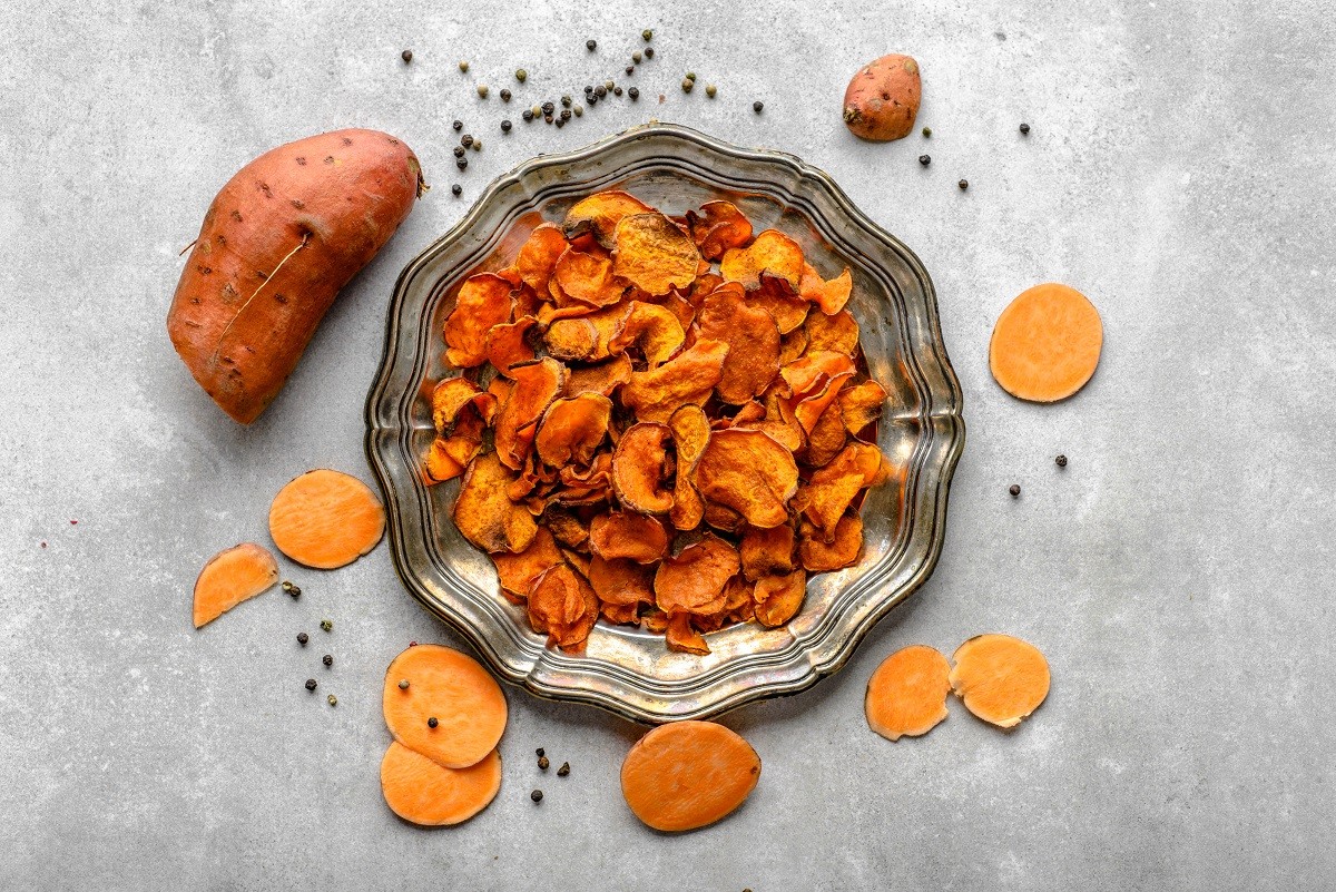 Fried potato, sweet chips with seasoned with paprika and salt, vegetarian snack on plate