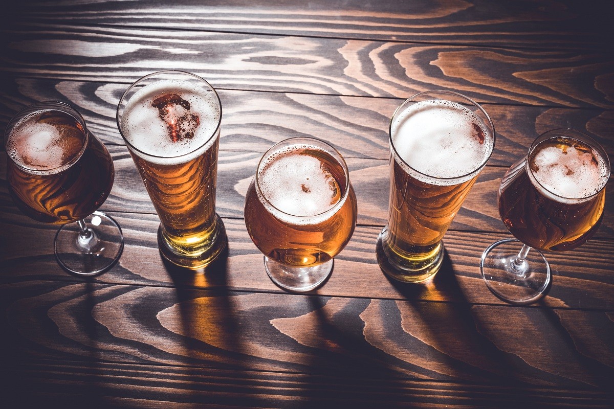 Beer glasses on an old dark wooden table. Top view