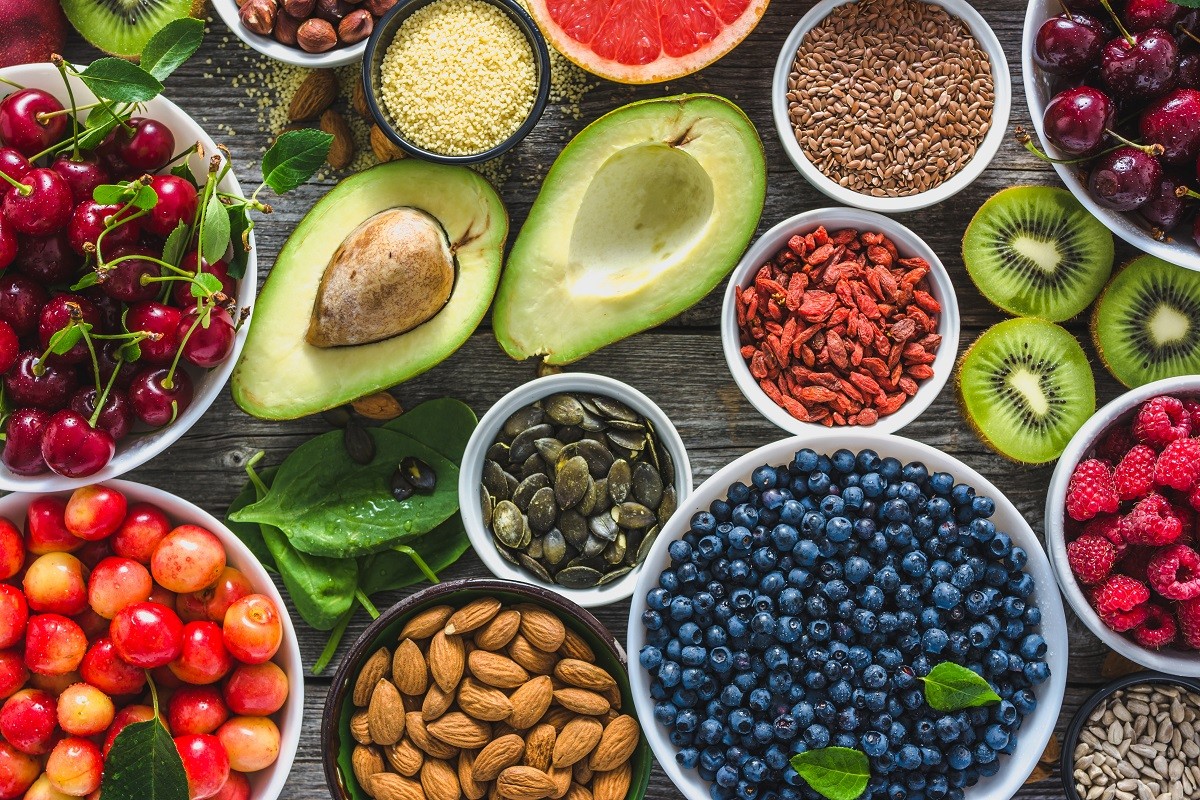 Healthy food selection, nuts, fruits and assortment of superfoods, top view