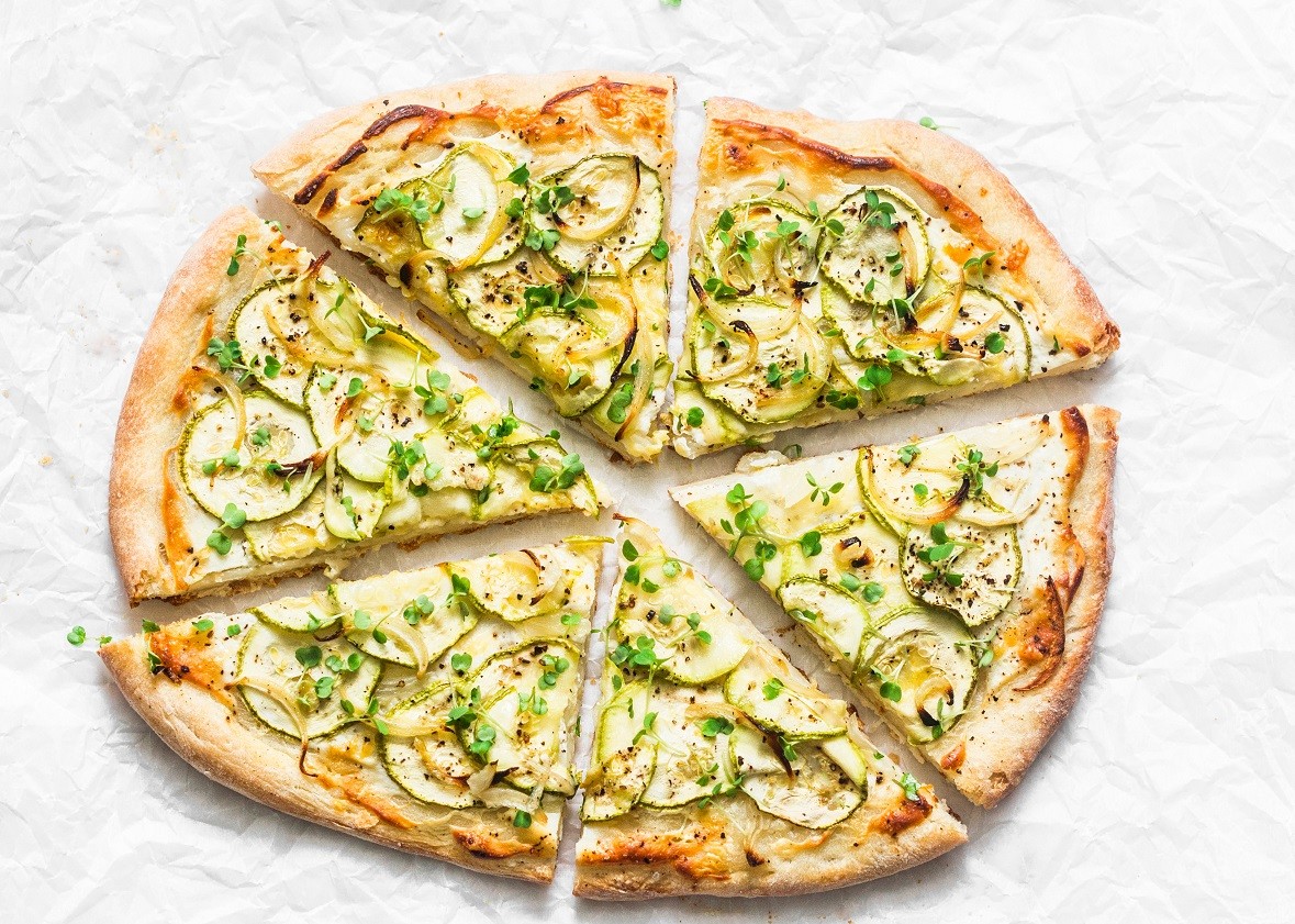 Vegan macadamia ricotta and squash pizza on light background, top view