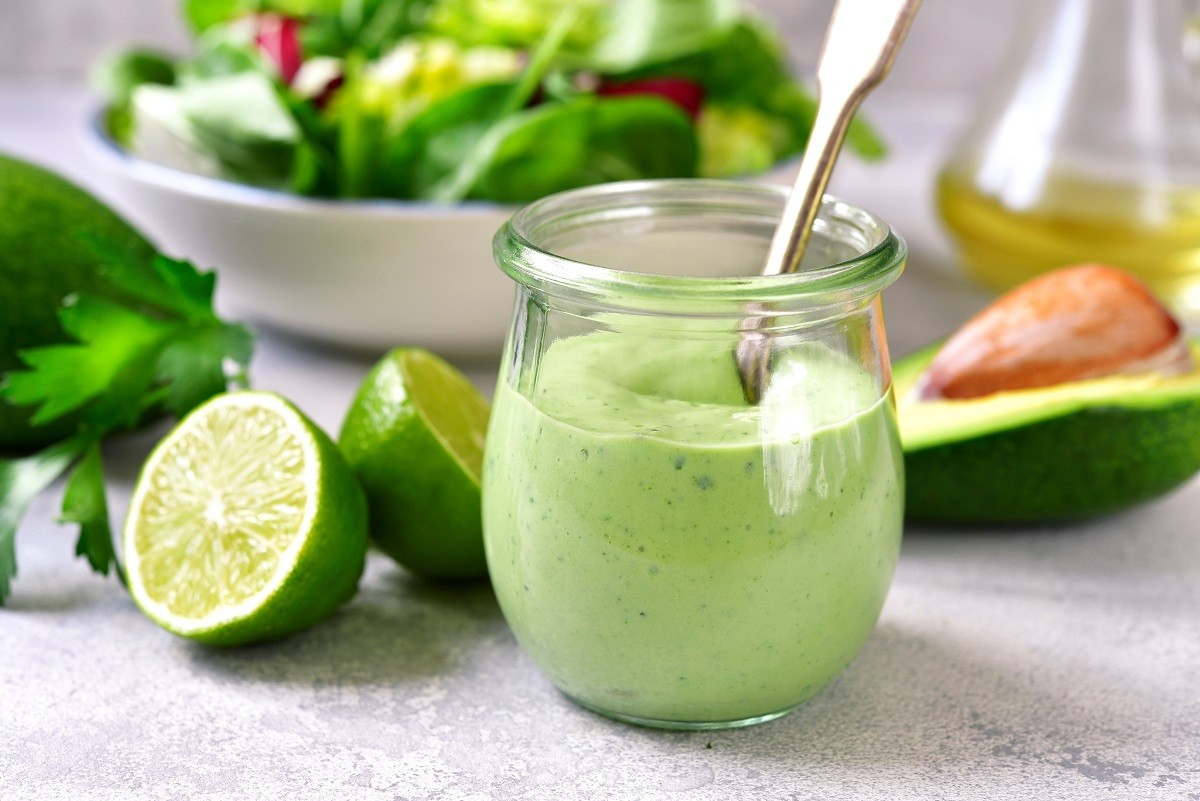 Homemade avocado yogurt dressing in a vintage glass jar.