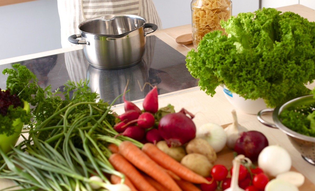 Young Woman Cooking in the kitchen. Healthy Food