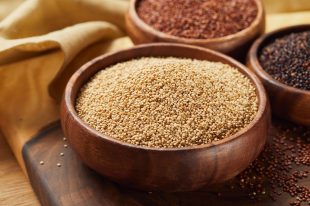 selective focus of white quinoa in wooden bowl