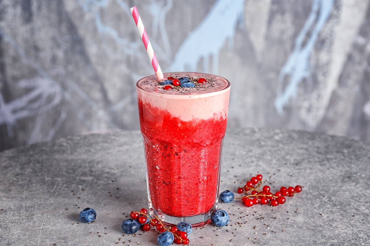 Glass of colorful smoothie with chia seeds on table