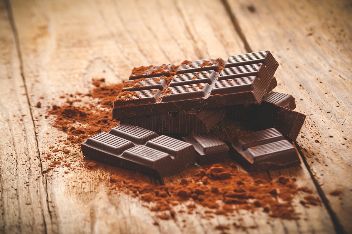 Noble dark chocolate on a wooden table in vintage style.
