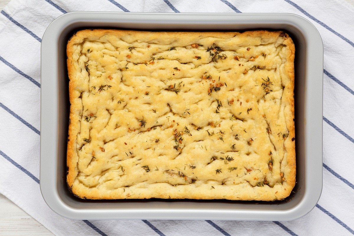 Home-baked Rosemary Garlic Focaccia Bread on baking tray, top vi