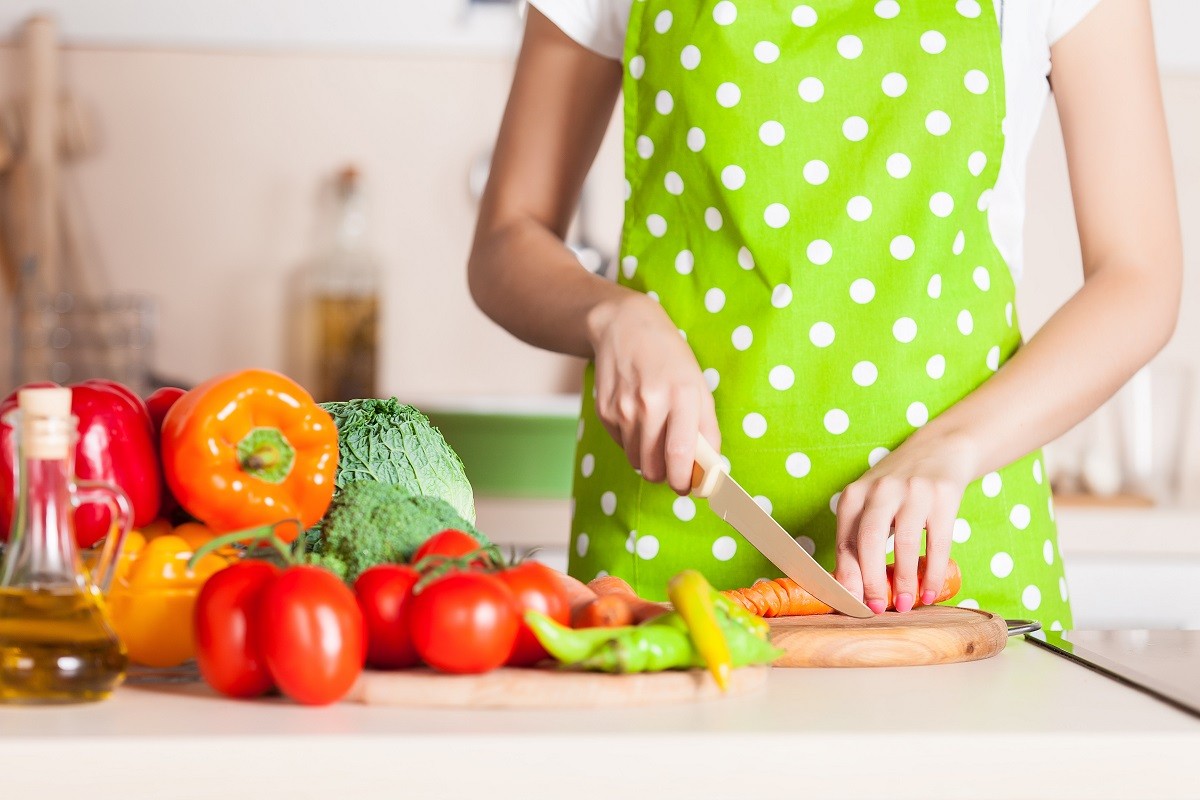 Human hands cooking vegetables salad in kitchen