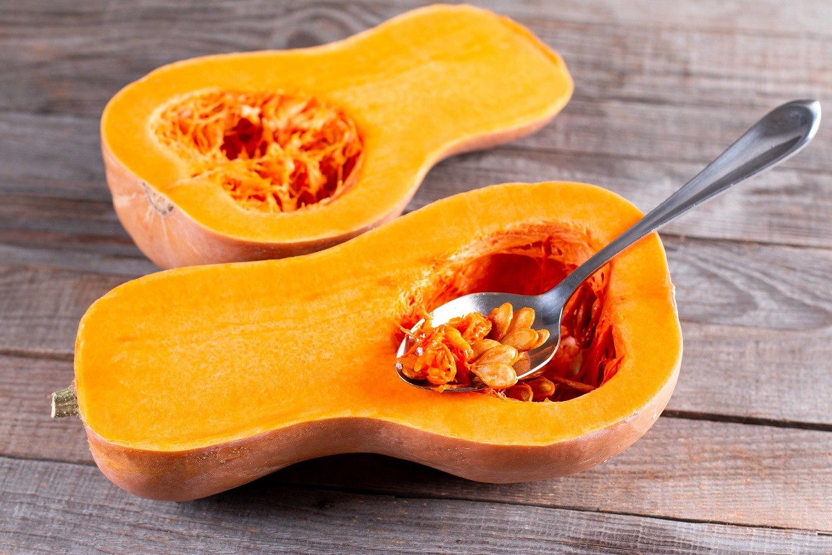 Take out pumpkin seeds with a spoon. Cooking squash, food ingredient