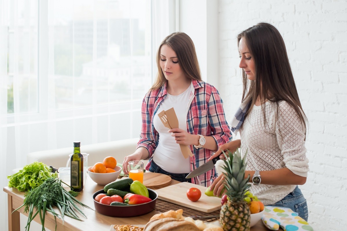 Gorgeous young Women preparing dinner in a kitchen concept cooking, culinary, healthy lifestyle.