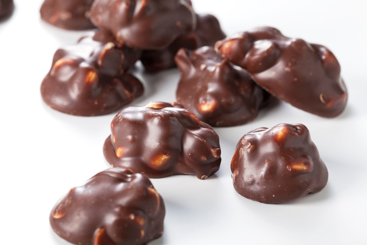 Chocolate pieces with nuts on a white background