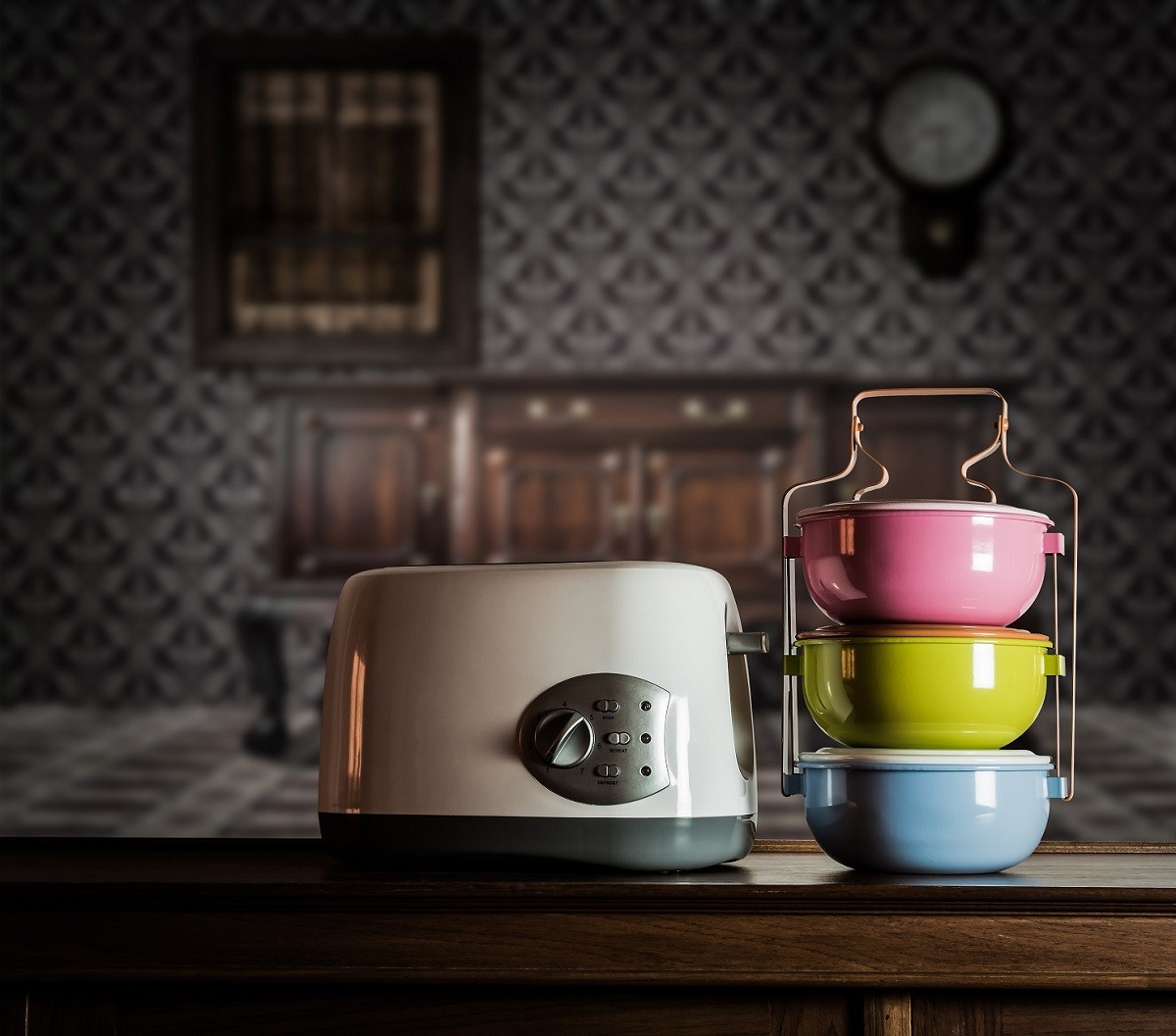 Colorful tiffin carrier and toaster on wooden cupboard
