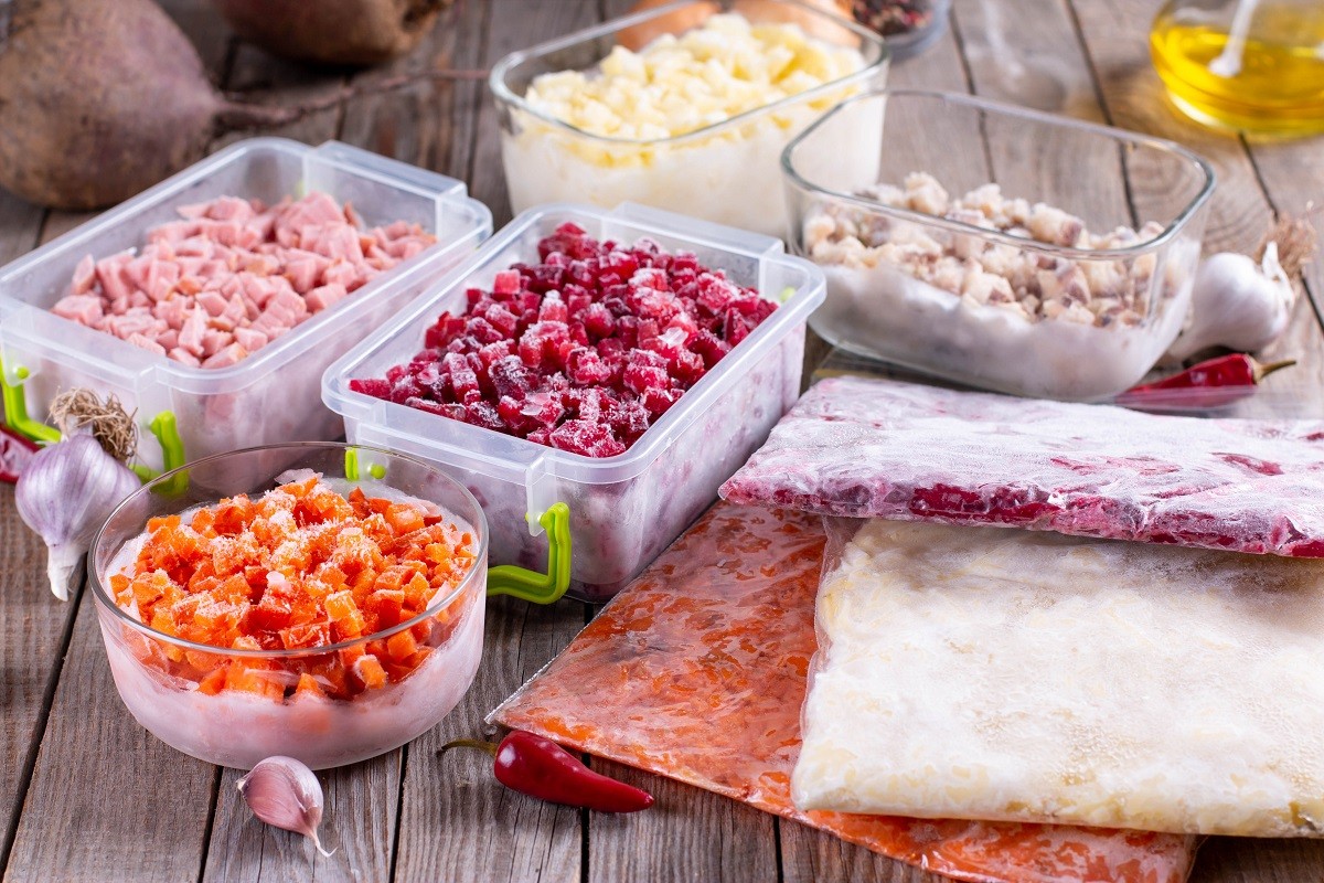 Frozen vegetables in containers on the table. Ready meals.