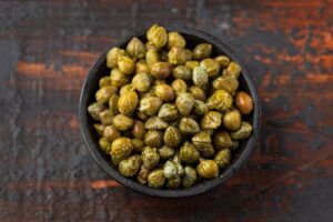 Marinated Pickled Capers in a wooden bowl