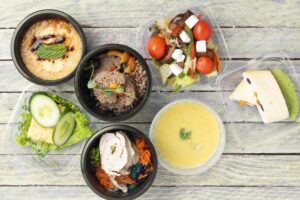 Ready meal to eat in seven food containers. healthy meals from take away lunch boxes. Proper nutrition concept, flat lay food