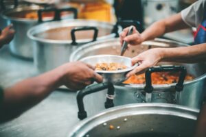 Feeding the poor to hands of a beggar, feeding food for beggar poverty concept